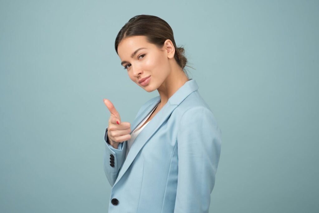 woman wearing blue shawl lapel suit jacket being confident